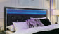 Kaydell King Upholstered Panel Storage Platform Bed with Mirrored Dresser and Chest Wilson Furniture (OH)  in Bridgeport, Ohio. Serving Bridgeport, Yorkville, Bellaire, & Avondale